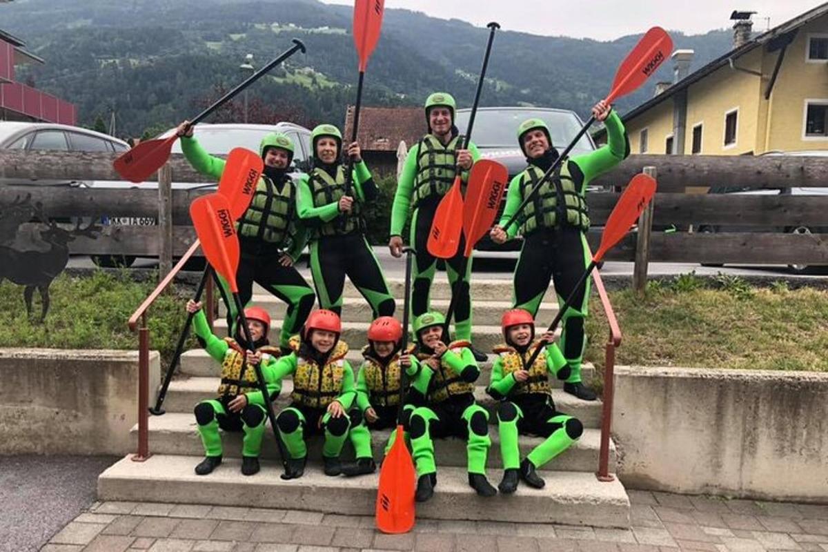a group of people are posing for a picture with kayaks