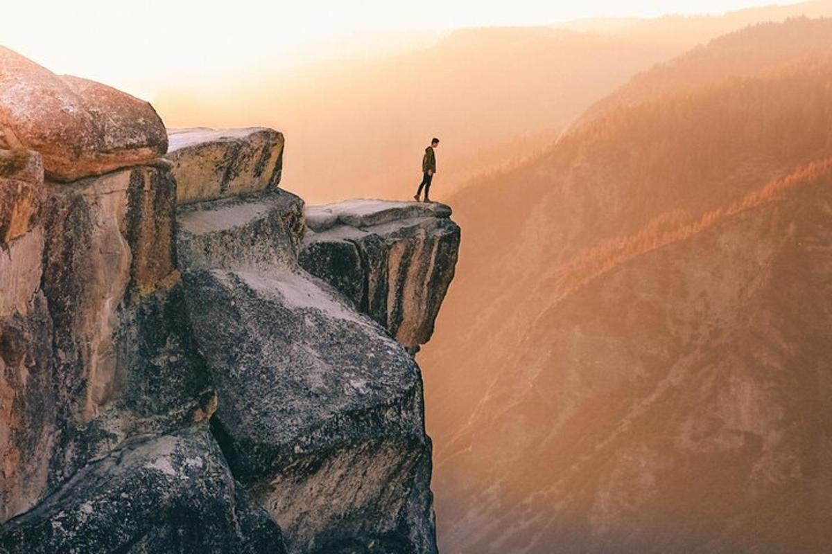a man standing on the edge of a mountain