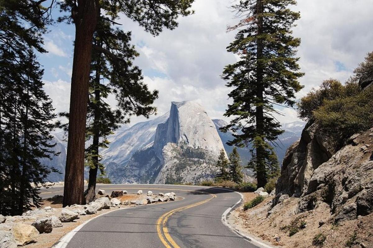a winding road with a mountain in the background