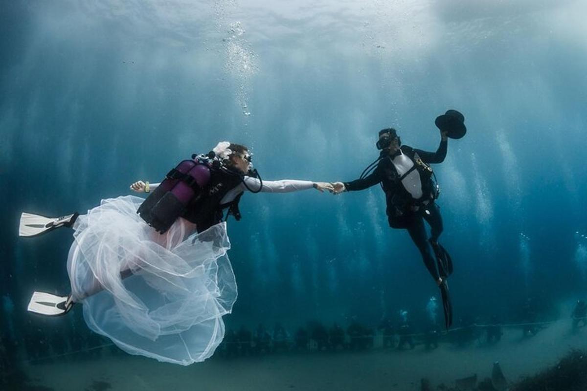 a bride and groom submerged in the water