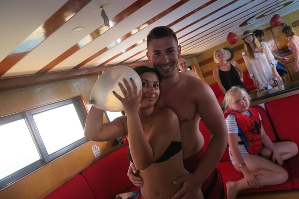 a man and a woman holding a volley ball