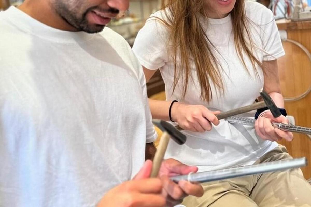 a man and a woman holding baseball bats