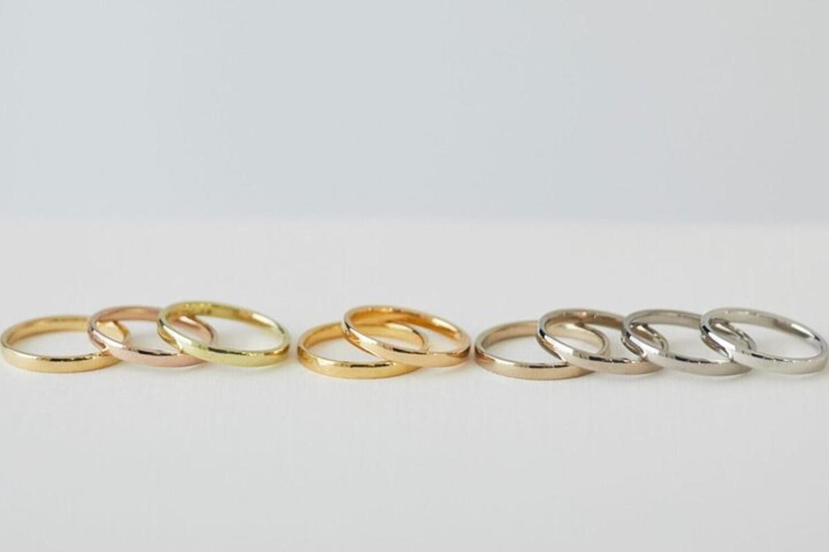a row of gold hoop earrings on a white background