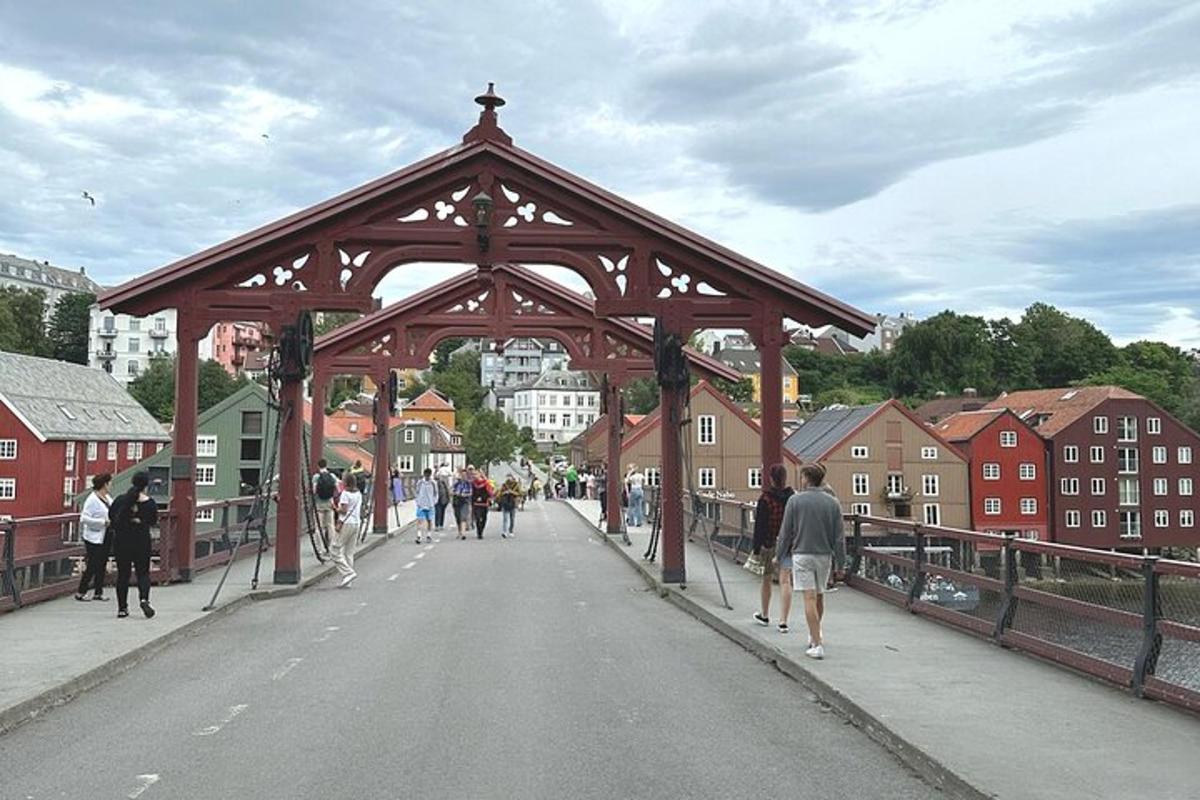 a large wooden bridge with people walking on it