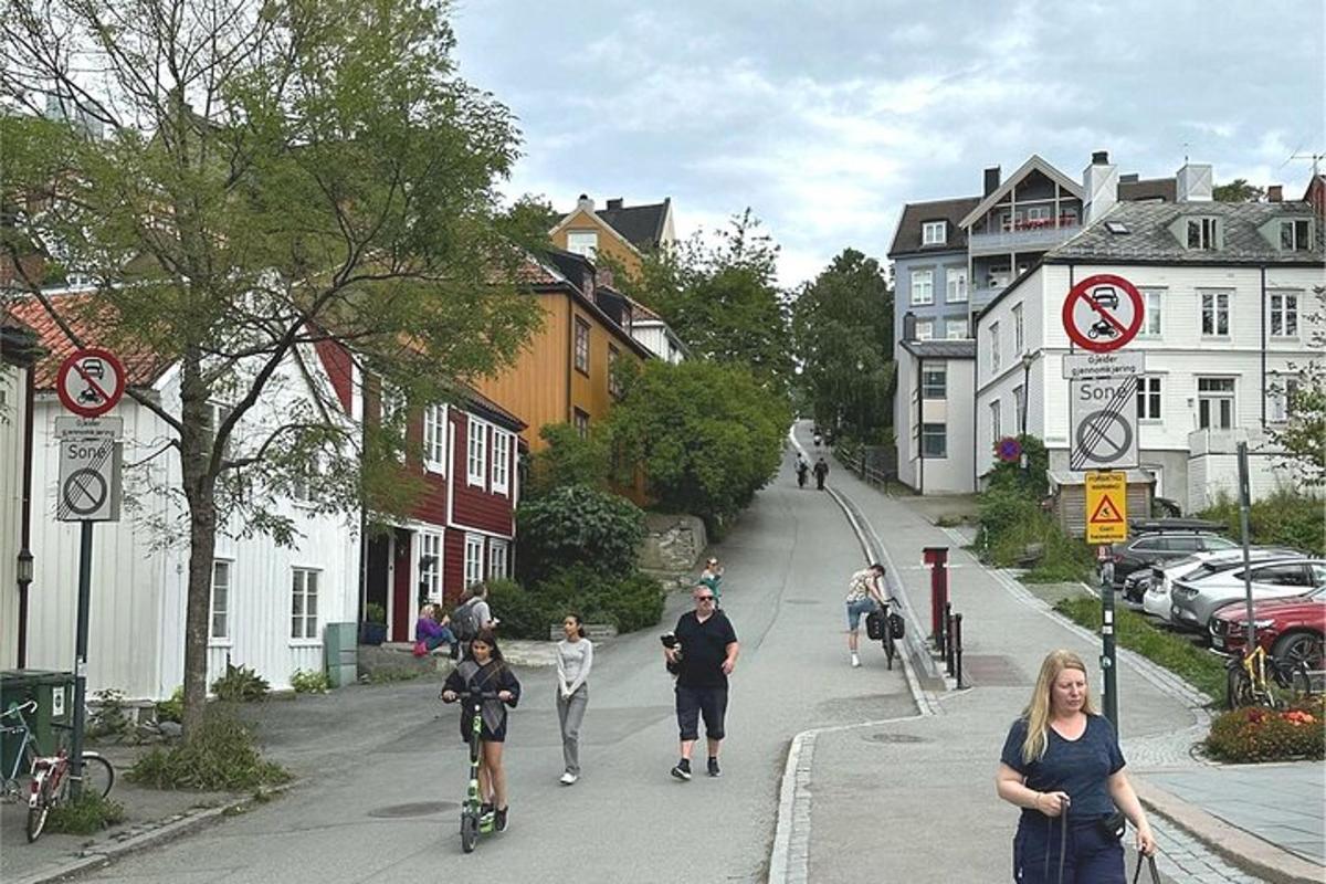 a group of people walking and riding bikes down a street
