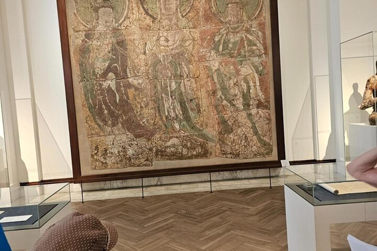 a large tapestry hanging on a wall in a museum