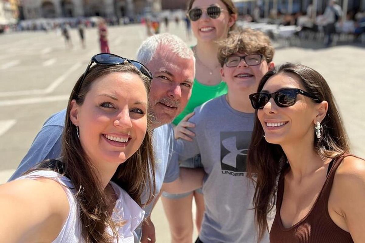 a group of people posing for a picture at the beach