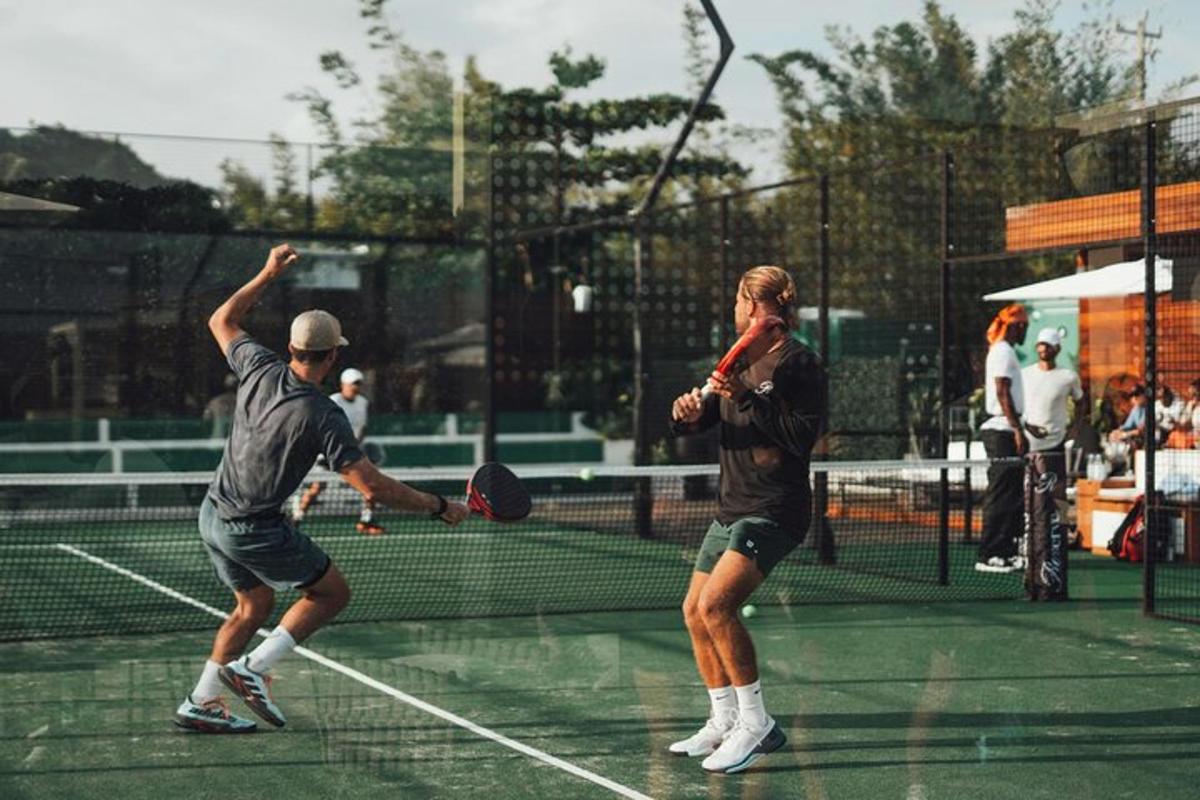 two men playing tennis on a tennis court