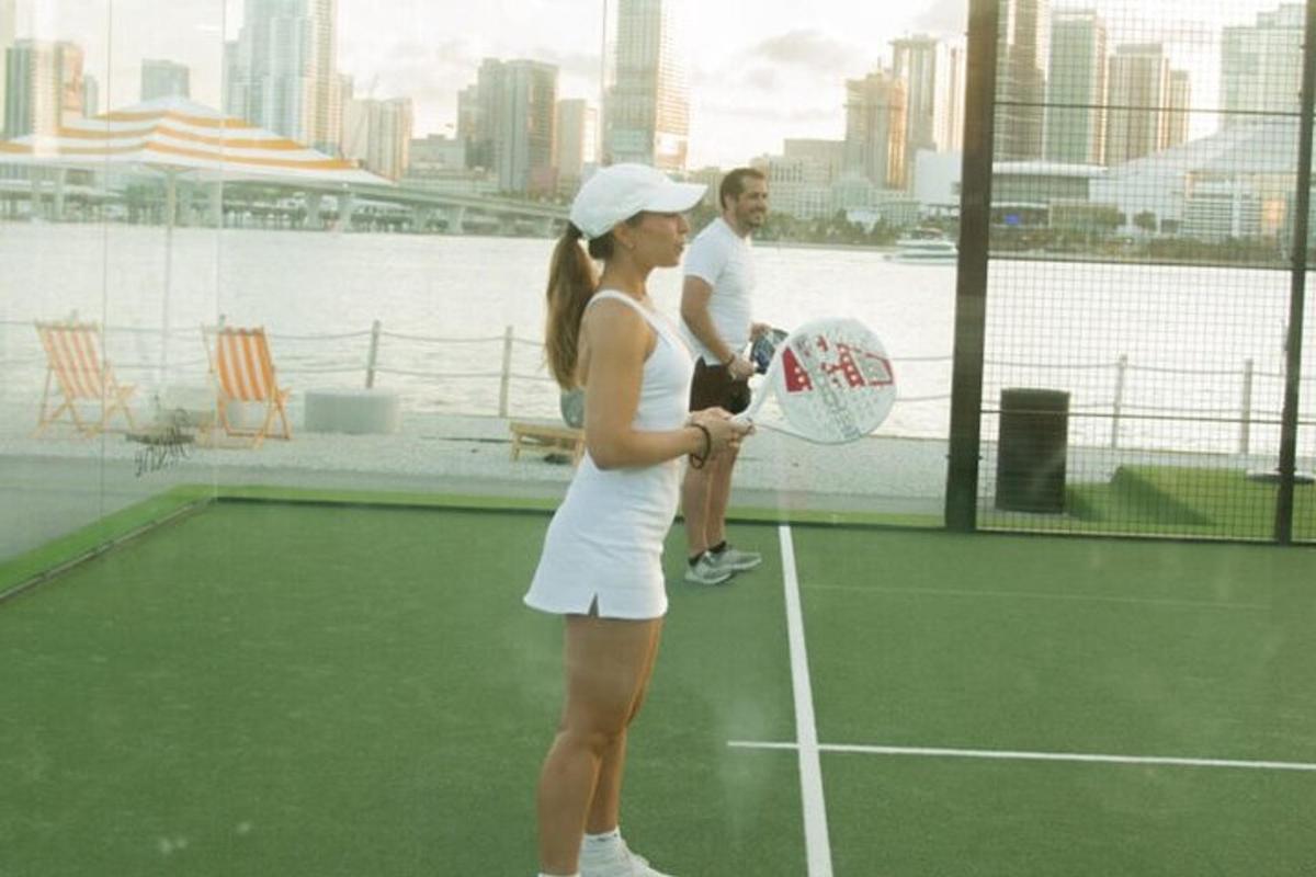 a woman holding a tennis racket on a tennis court