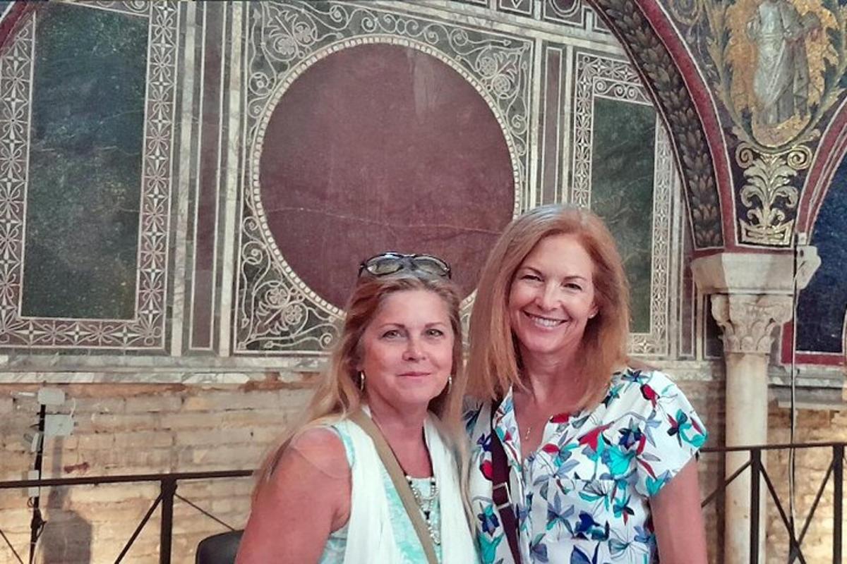 two women standing in front of a building