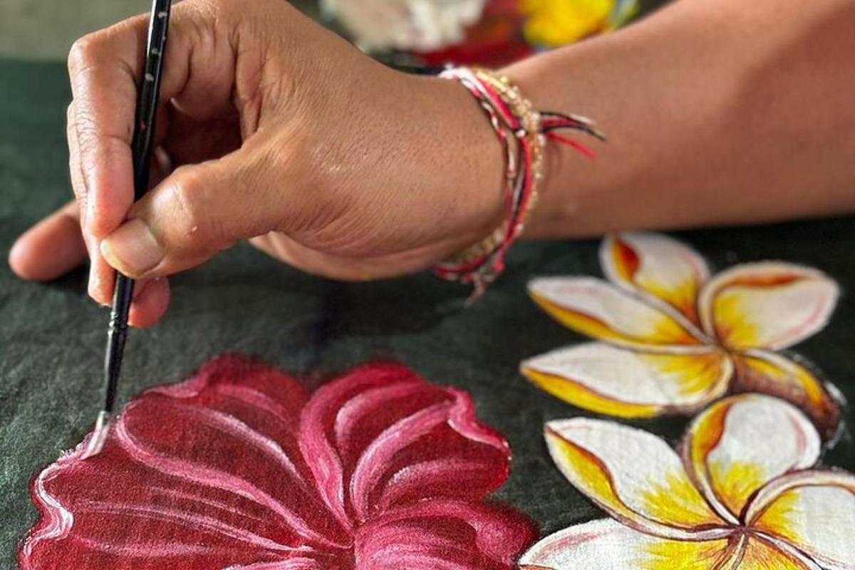 a person cutting a red flower on a table