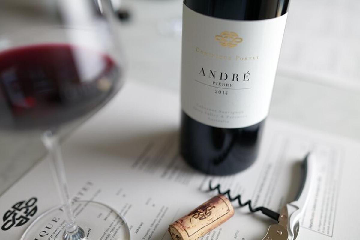 a bottle of wine and a glass of red wine