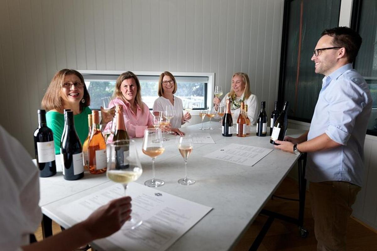 a group of people sitting around a table with wine glasses