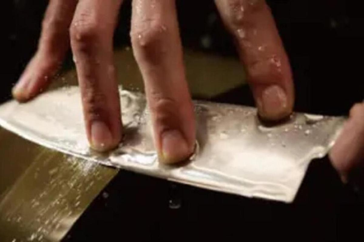 a person is cutting something on a knife