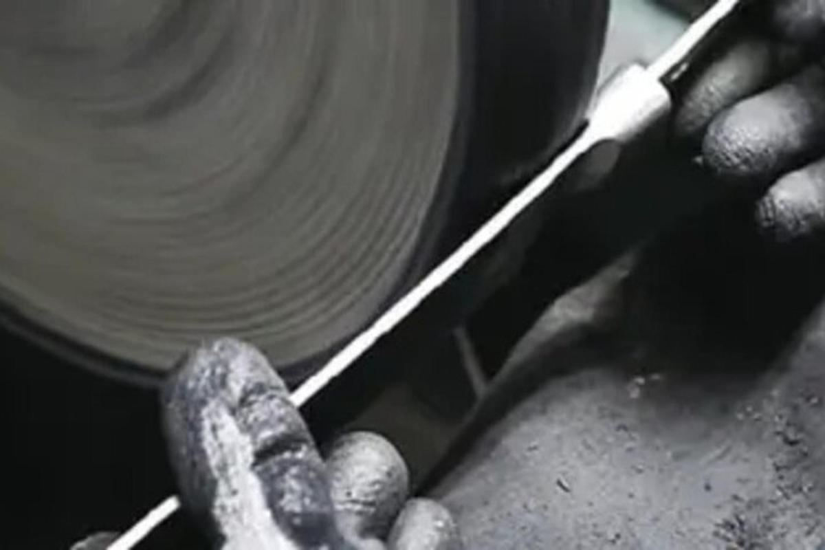 a person is cutting a plate with a pair of scissors