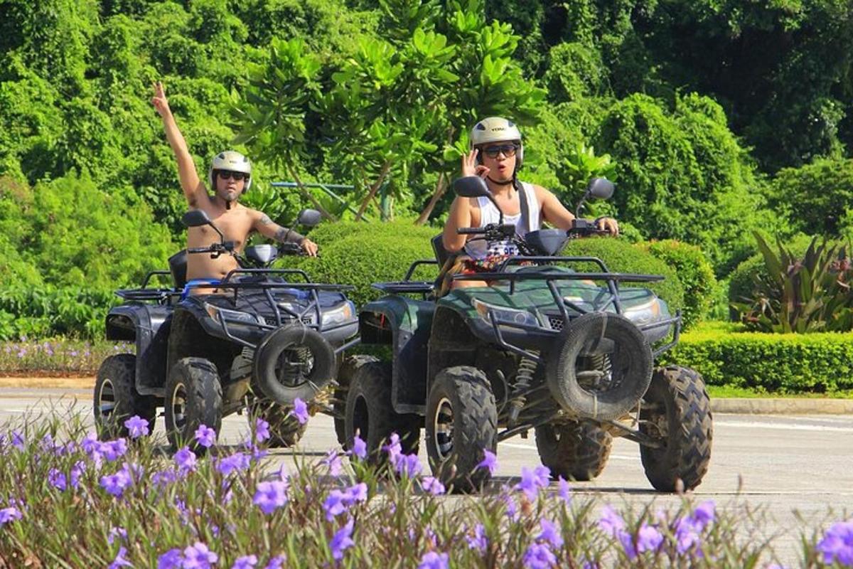 two people riding atvs down a road