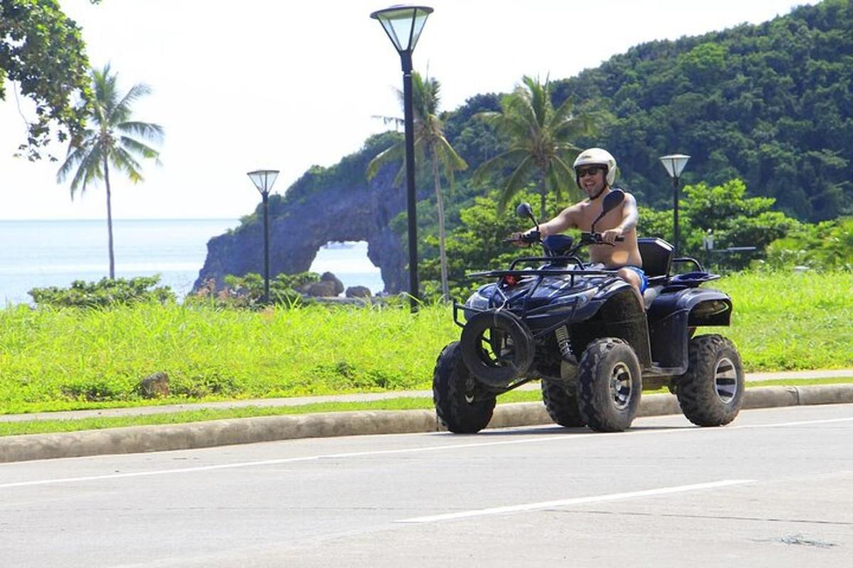 a man riding a quad bike down a street