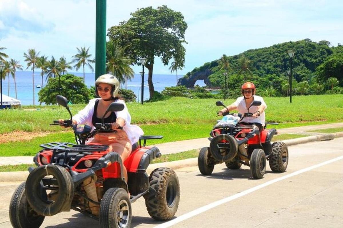 two people are riding atvs on a road