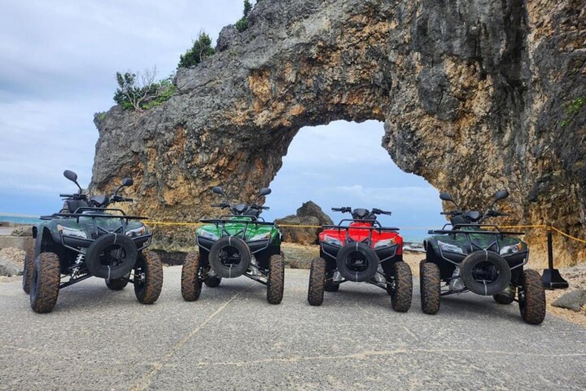 three atvs parked in front of a rock formation