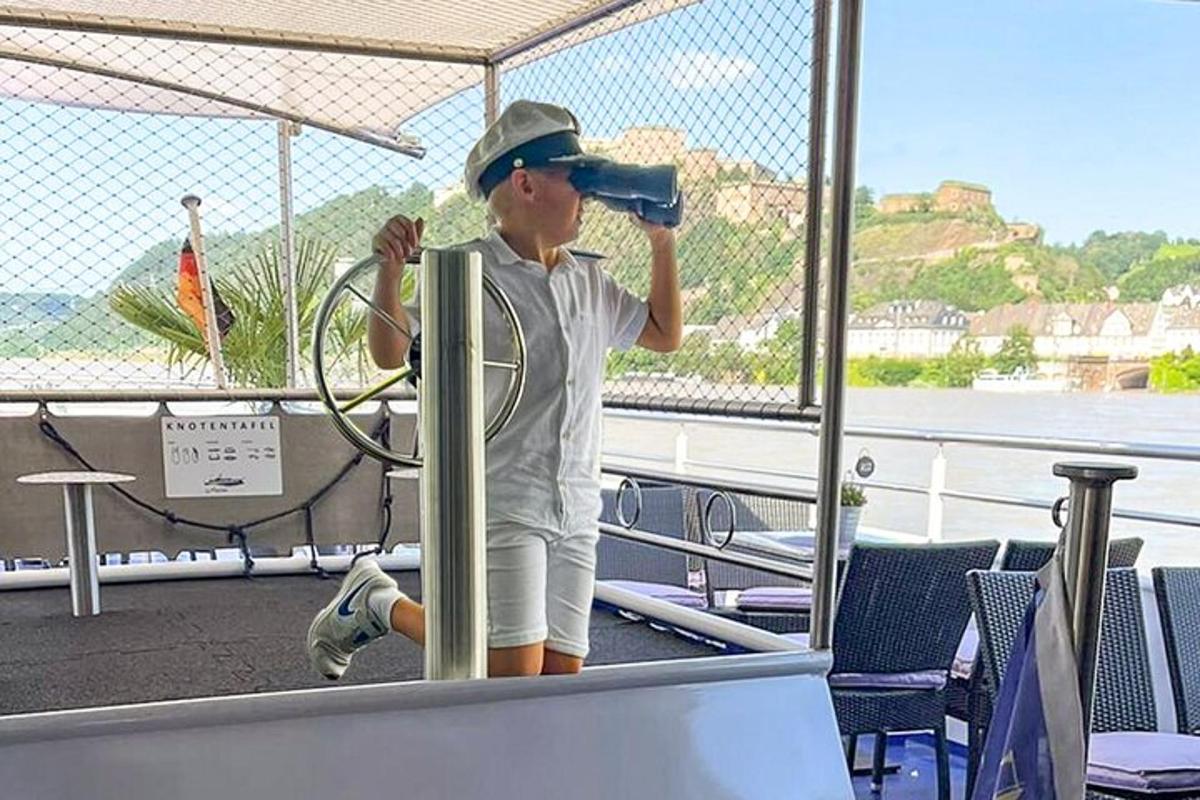 a man standing on a boat drinking from a bottle