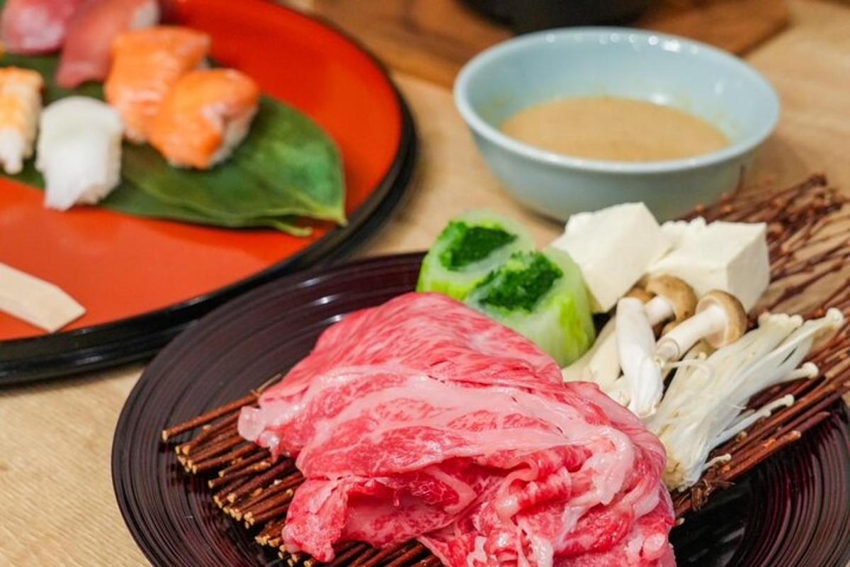 a table with two plates of food and a bowl of soup