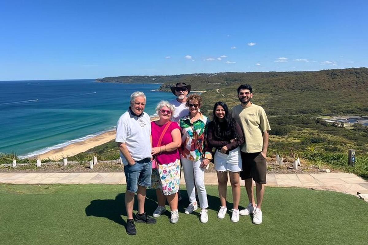 a group of people standing in front of the ocean