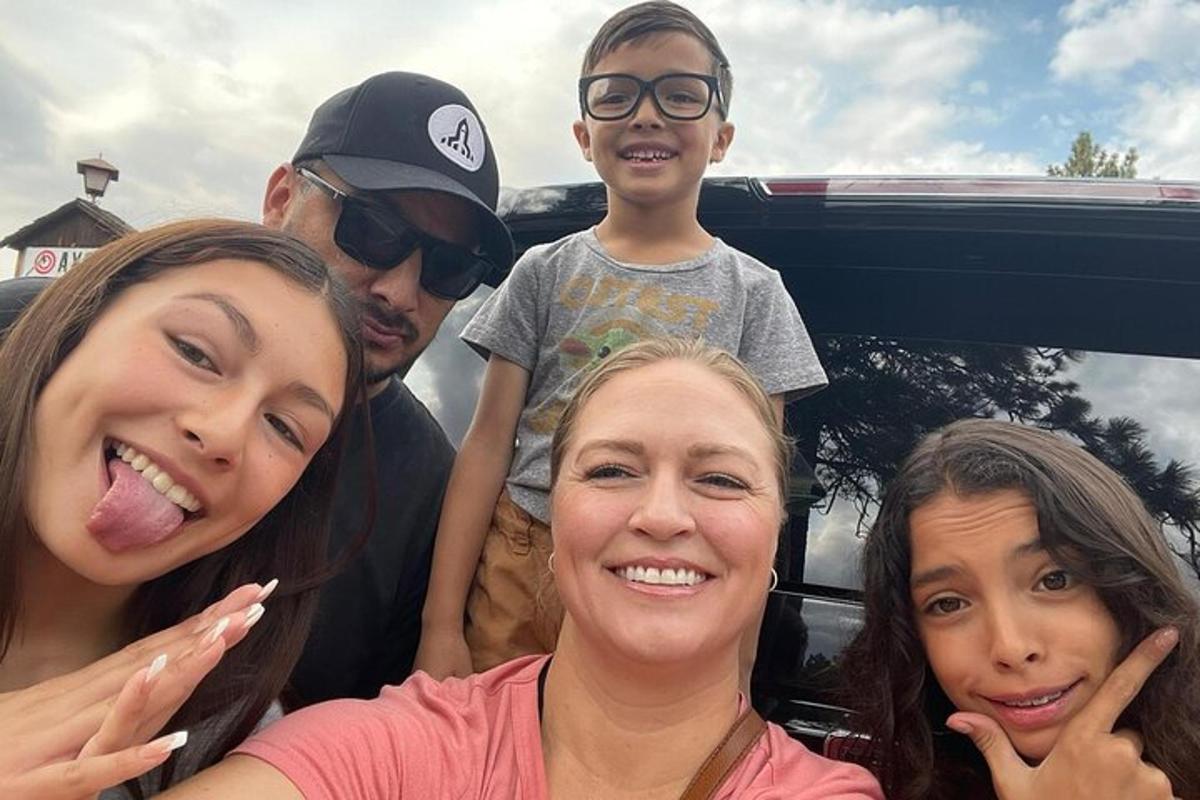a group of people standing in the back of a truck