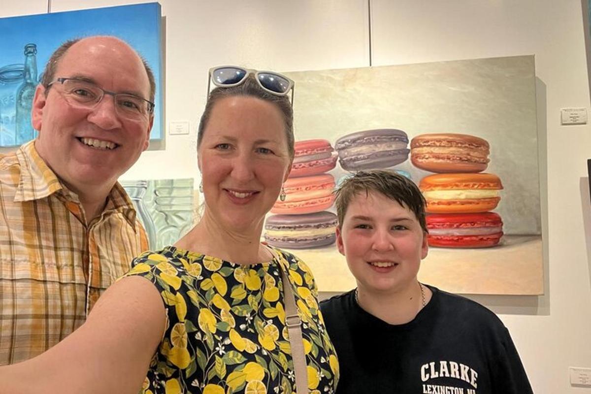 a man and a woman standing next to a boy
