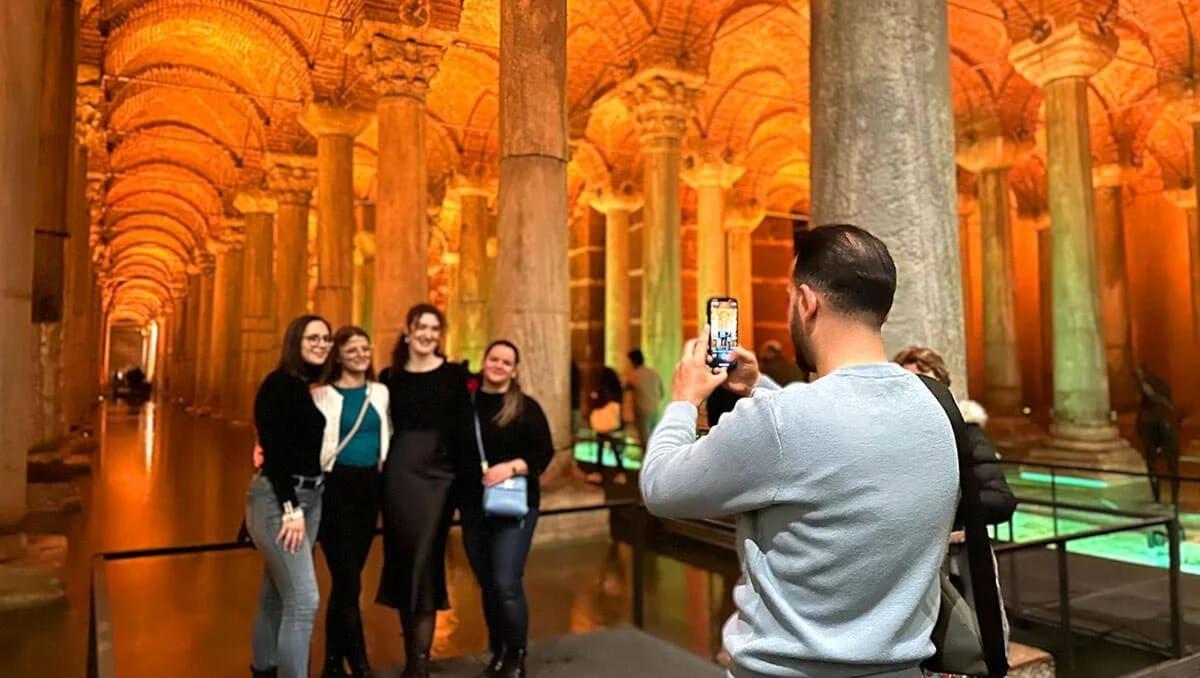 un uomo che scatta una foto a un gruppo di persone in un museo