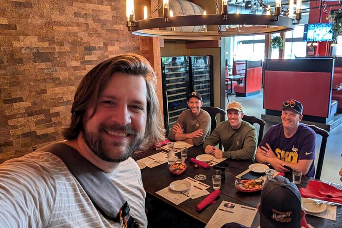 a group of men sitting at a table in a restaurant