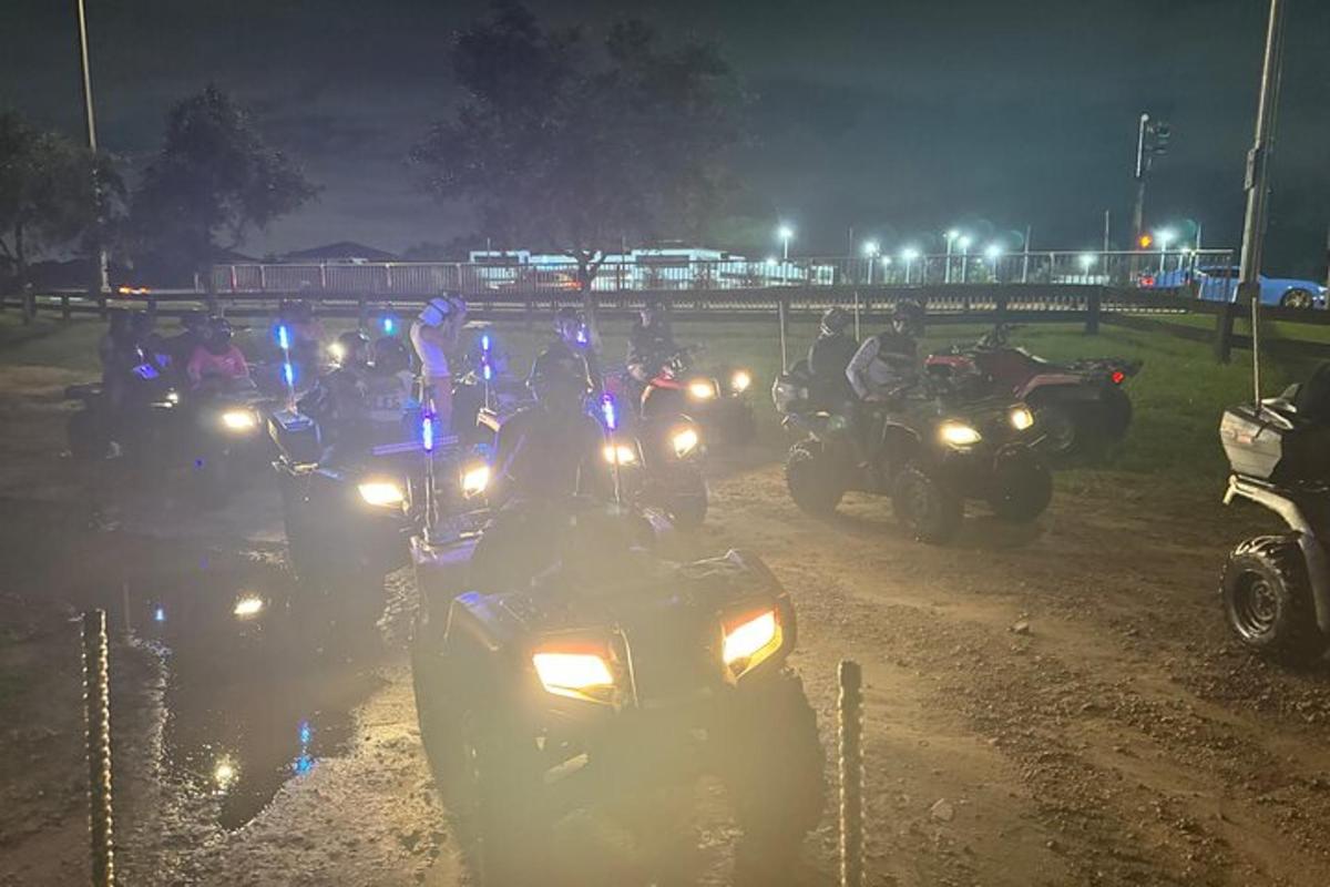 un gruppo di persone in moto su una strada sterrata di notte