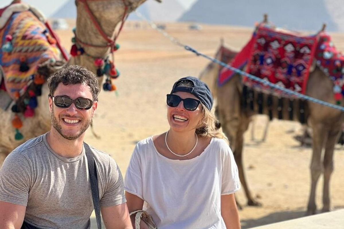 ein Mann und eine Frau stehen neben einem Kamel