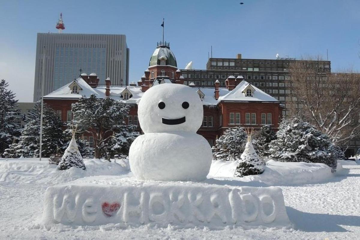 a snowman in the snow in front of a building