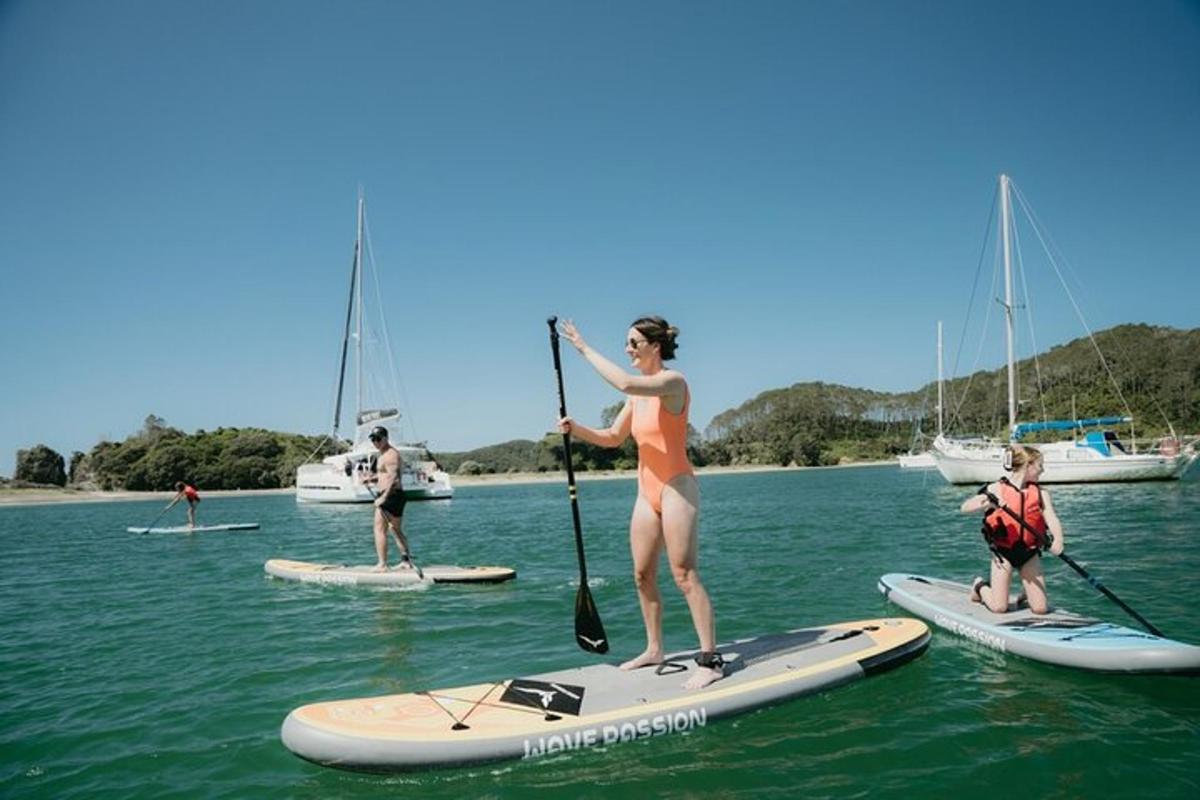 a woman standing on a paddle board in the water
