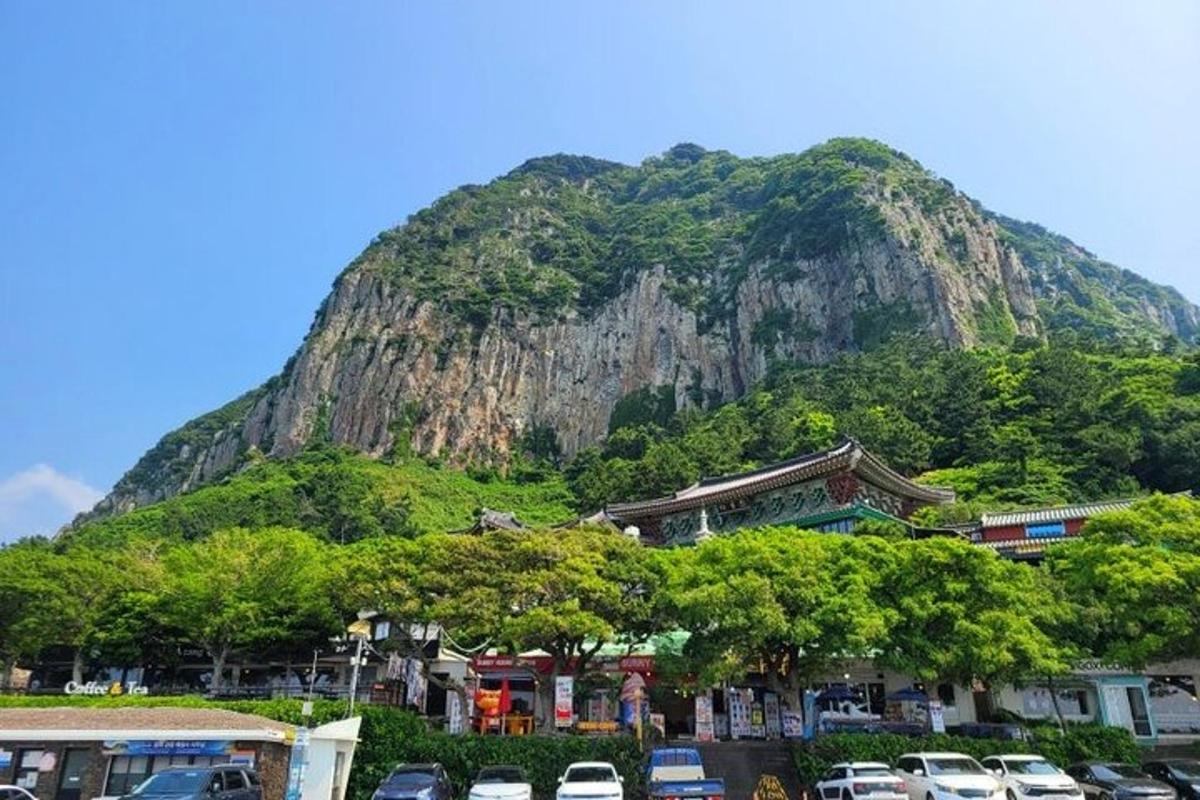 a mountain with cars parked in a parking lot