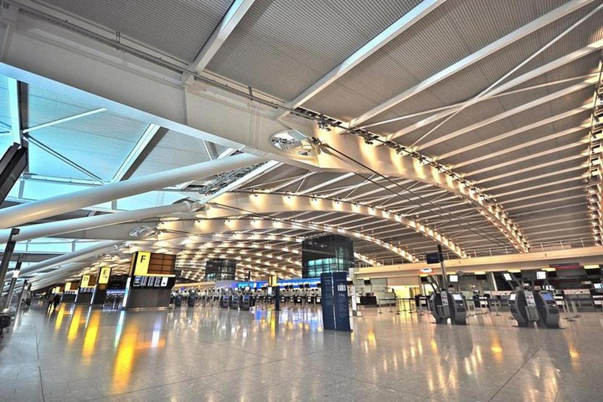 an empty airport terminal with luggage carts and lights