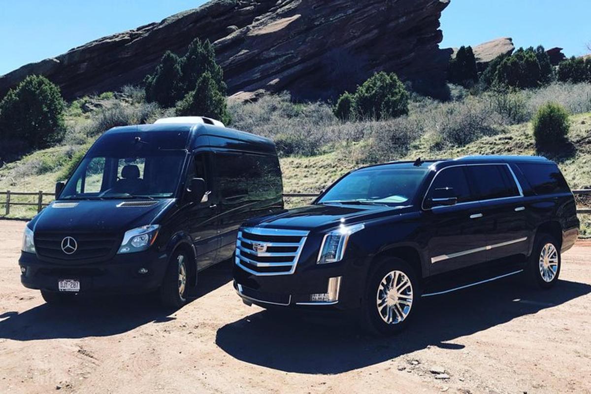 a black suv parked next to another