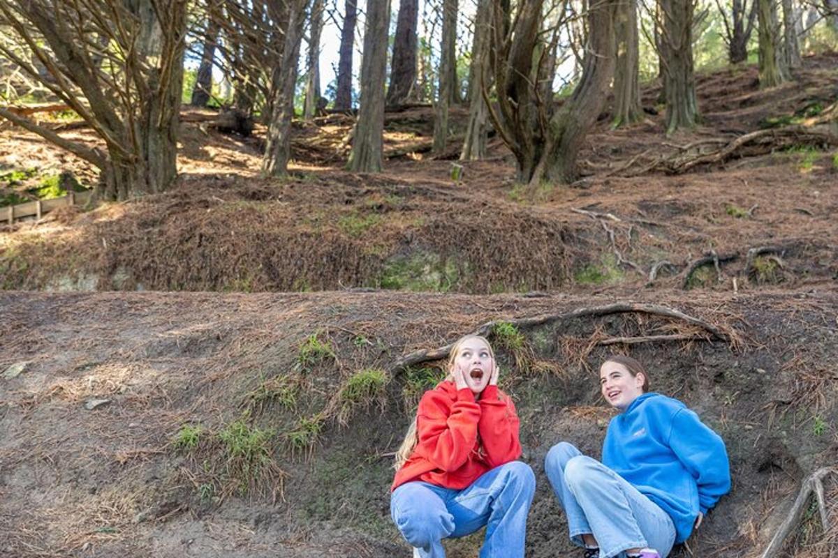 duas crianças sentadas no chão da floresta