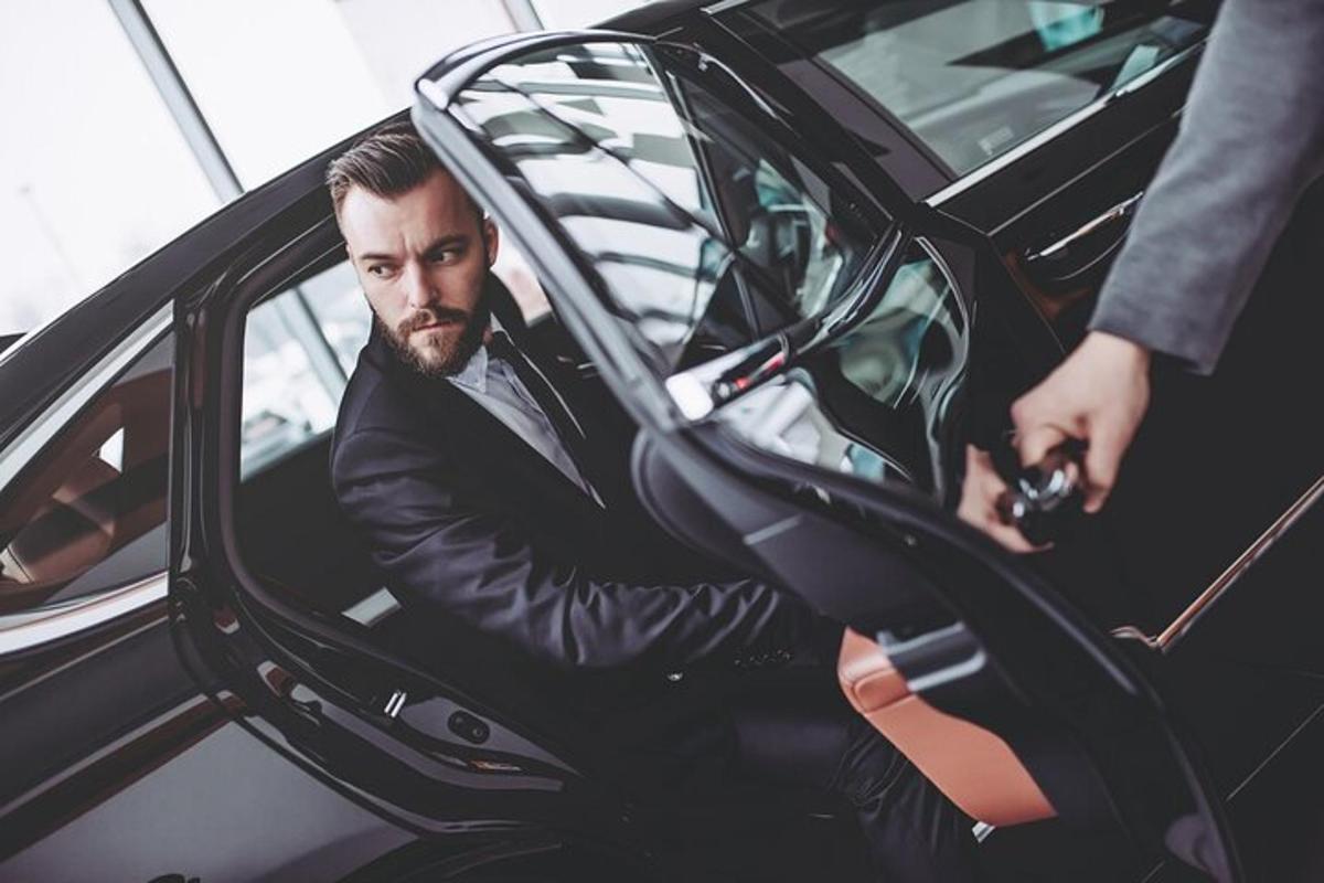 a man in a suit getting out of a car