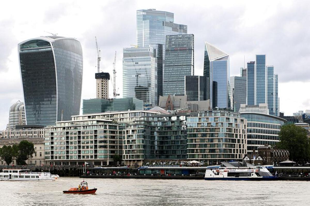 a boat on the water in front of a city