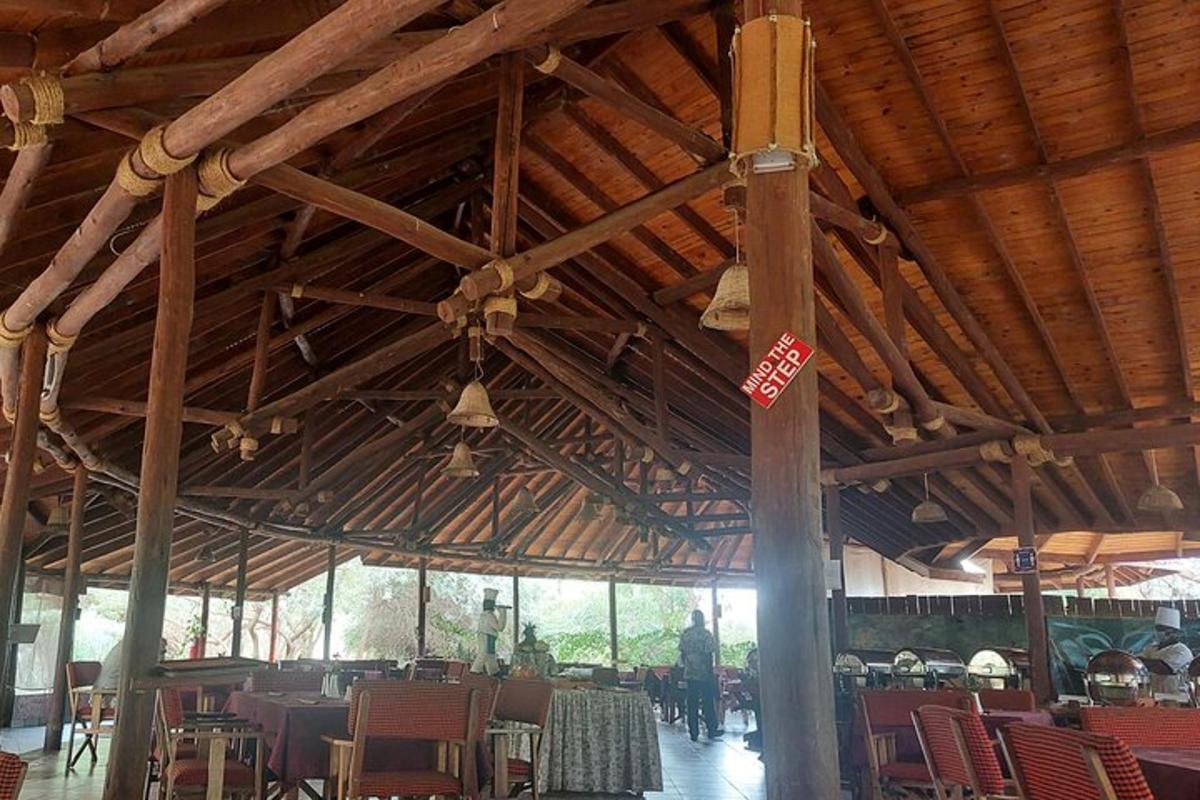 a large wooden building with tables and chairs