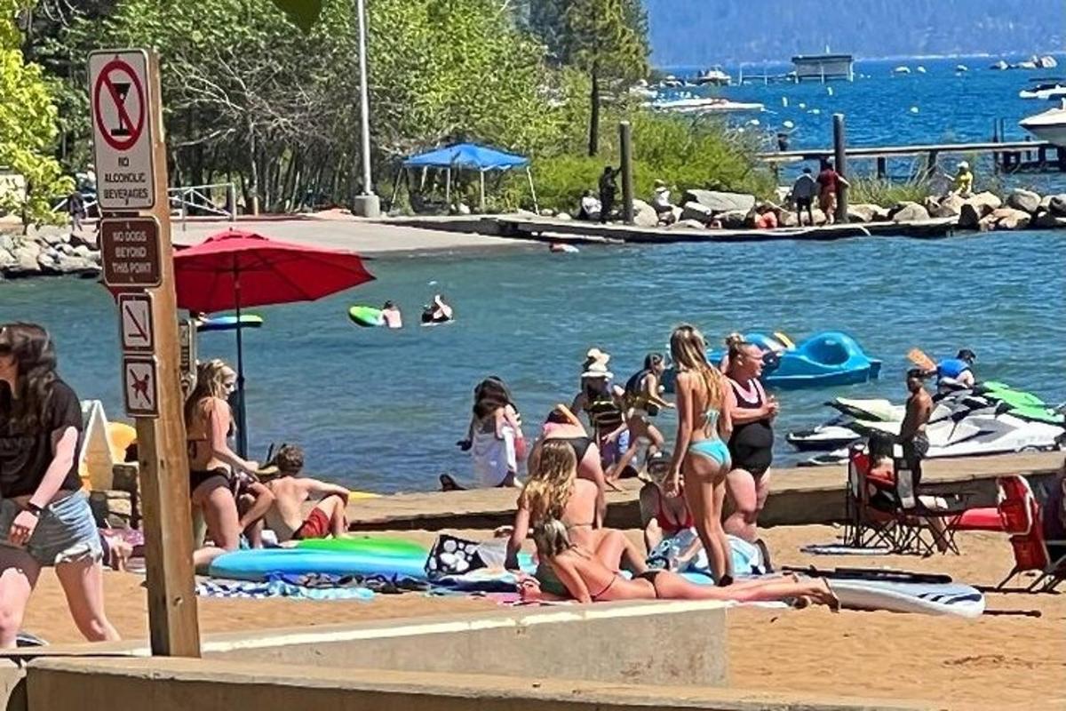 un grup de oameni pe plajă, lângă apă