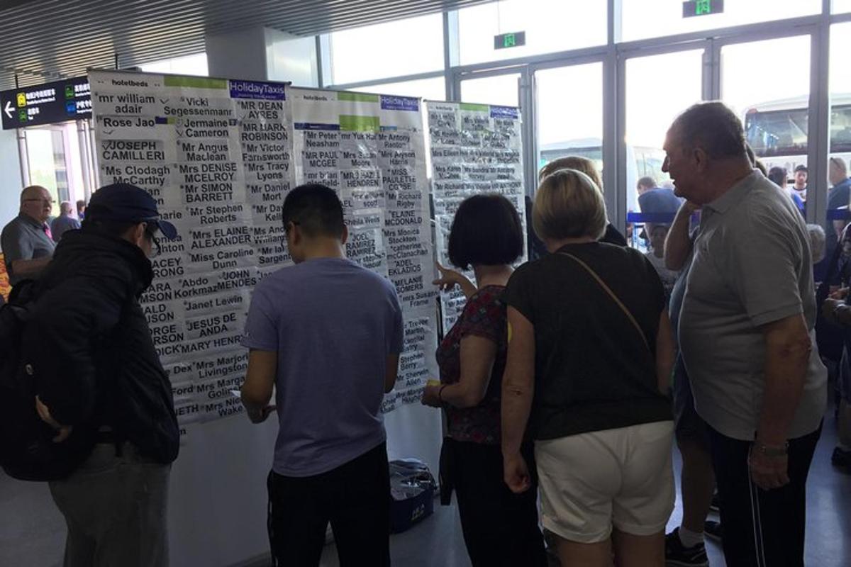 a group of people standing in front of a large poster