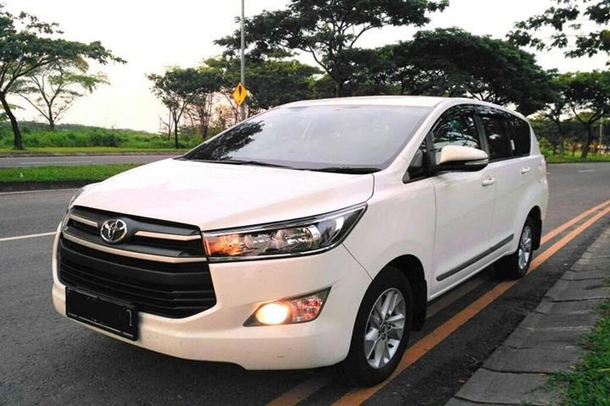 a white car parked on the side of a road