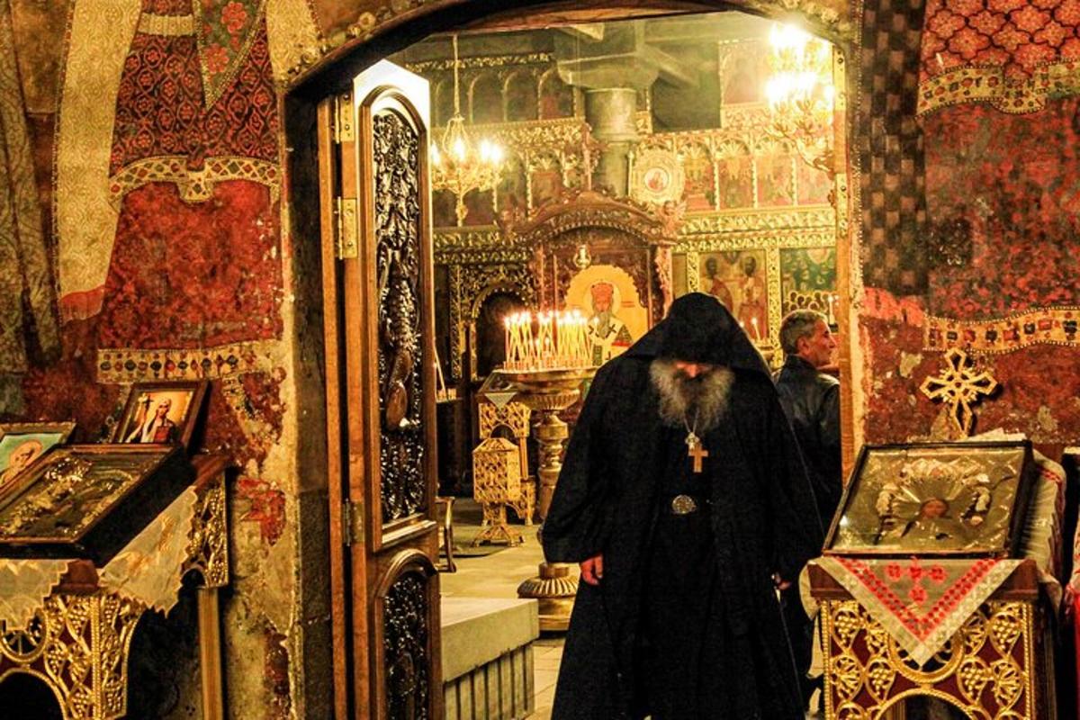 a woman in a black coat walking through a room