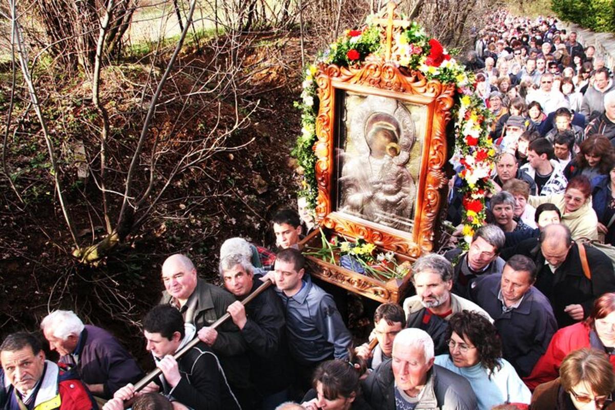 a large group of people holding a picture of a statue