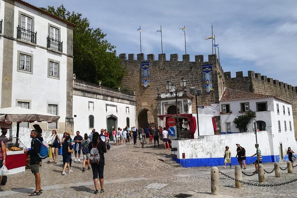 a group of people standing in front of a castle