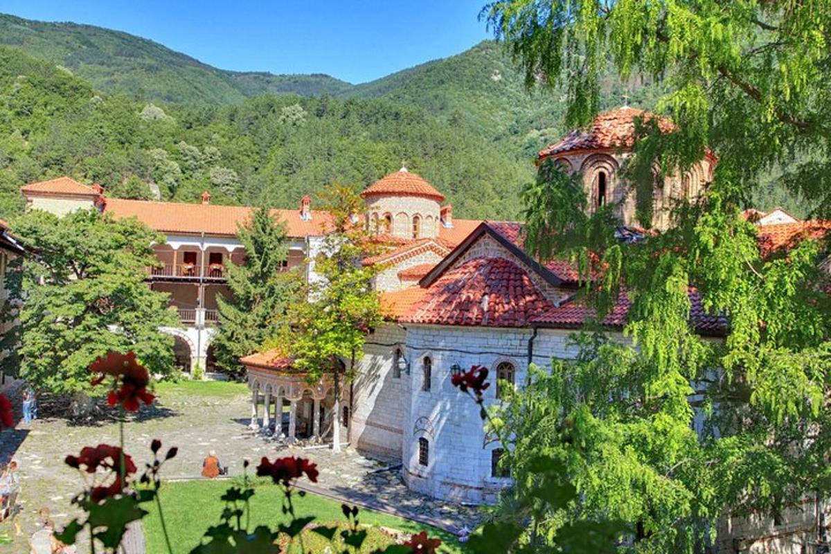 a large building with a house in the mountains