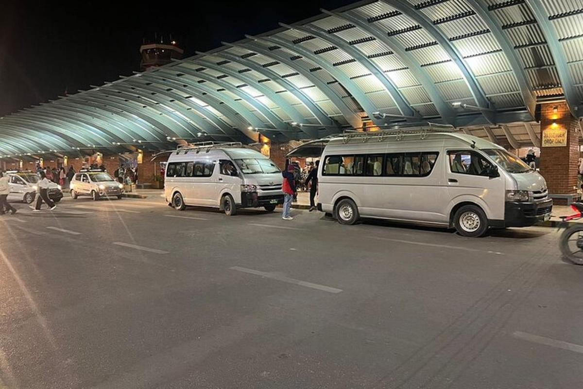 two vans parked in a parking lot at an airport