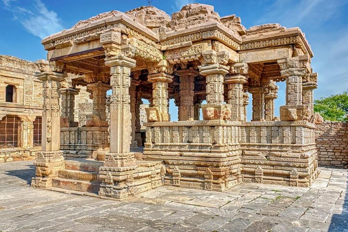 a large stone building with a pillar in front